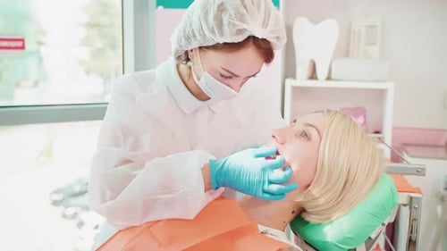 Dentist Examination in Modern Stomatology Clinic Female Patient and Woman Doctor in Office
