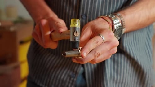 Crafting a Ring Design on Metal With Precision Tools in a Workshop Setting hammering
