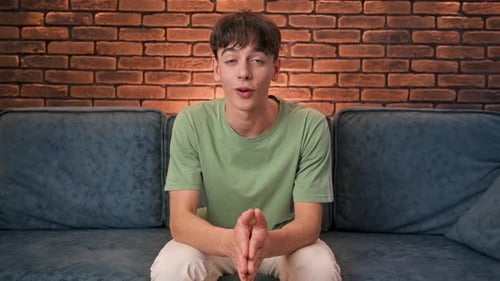 Young Adult Speaking and Gesturing on Couch