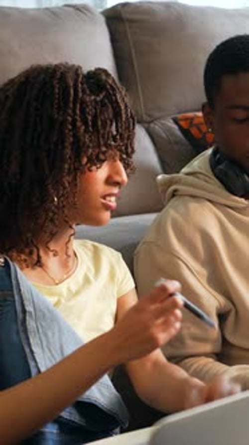 Young Woman and Man Work on Laptop at Home
