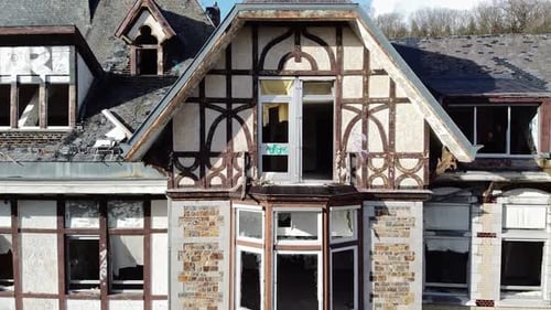Moving away from a broken window of an abandoned hospital.