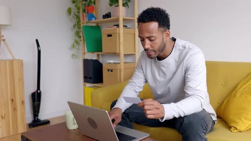 Young Adult Shopping Online With Laptop at Home