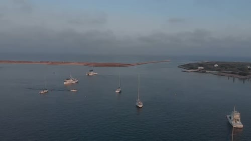 Aerial view of beautiful bay with boat passing by. Ocean in the horizon.