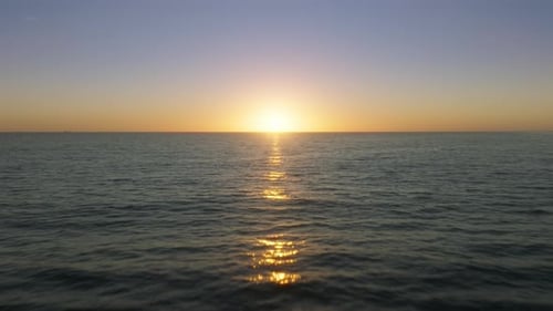 Golden Hour Lighting Reflecting on Tranquil Sea Waves in Exotic Environment