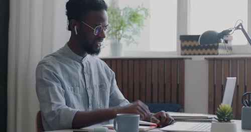 Young Adult Attends Online Meeting at Desk