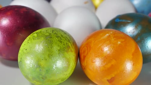 Colored eggs rotate in a basket. Easter eggs in all colors