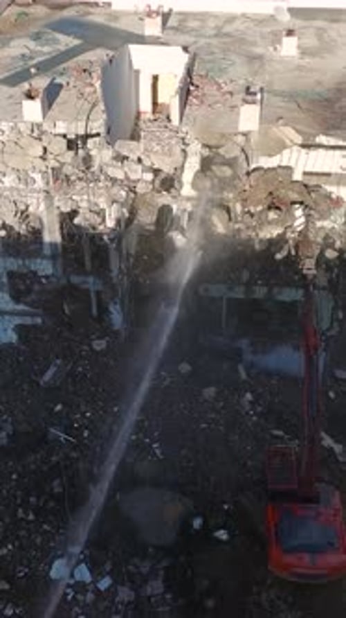 Vertical Video A Hydraulic Excavator Efficiently Demolishes an Old Building Clearing the Land for
