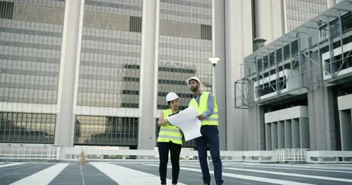 4k video footage of two young engineers using a digital tablet while collaborating in the city