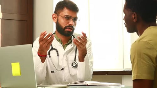 Indian Doctor Therapist in White Coat Consulting Supporting Patient in Modern Clinic Hospital
