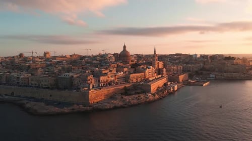Aerial Panorama of Valletta Old Town Basilica Dome and Spire at Sunset