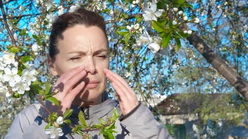 Lady with Pollen Allergy Symptom By Tree