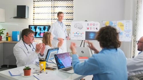 Medical Professionals Discuss Biohacking Research in Modern Office