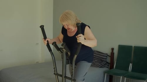Woman Exercising on Elliptical Machine at Home