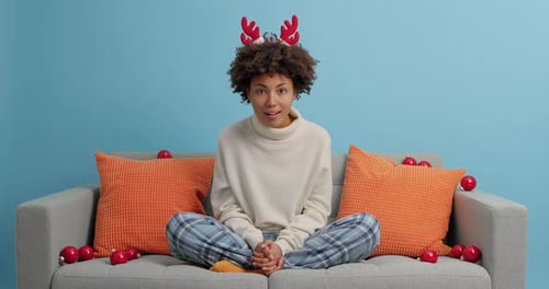 Excited Woman with Reindeer Antlers Celebrates the Holidays