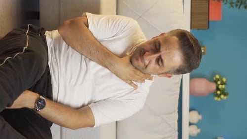 Vertical video of Sick man coughing leaning against wall. Hopeless.