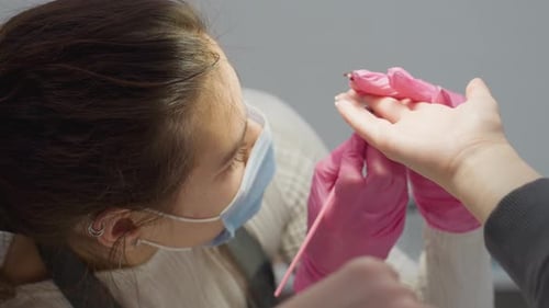 Manicurist Working on Client's Nails in Salon