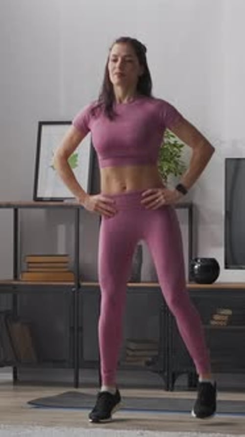 Woman Does Leg Exercise in Living Room