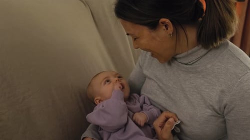 Happy young mother having a tender moment with her small baby - Concept family and motherhood