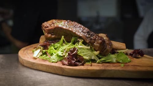 Rustic plated beer braised rib roast in professional restaurant kitchen, HD