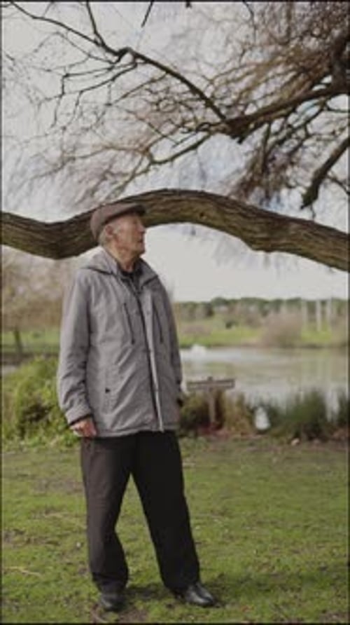 Elderly Man Enjoying Nature in a Serene Park