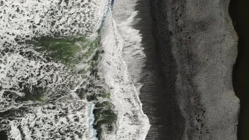 Top View of Waves Crashing on Black Sand Beach