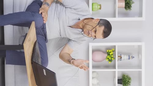 Man Working on Laptop, Presenting From Couch