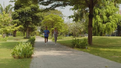 Couple Jogging Together on Sunday Morning Outdoors