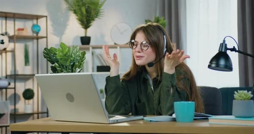 Young Woman in Online Meeting With Laptop