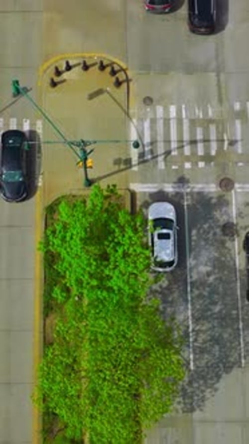 Traffic of a busy city at daytime. Automobiles moving quickly by the broad roads. View from top