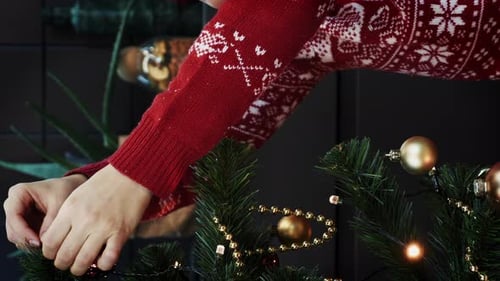 Decorating Christmas Tree with Ornaments in Festive Home