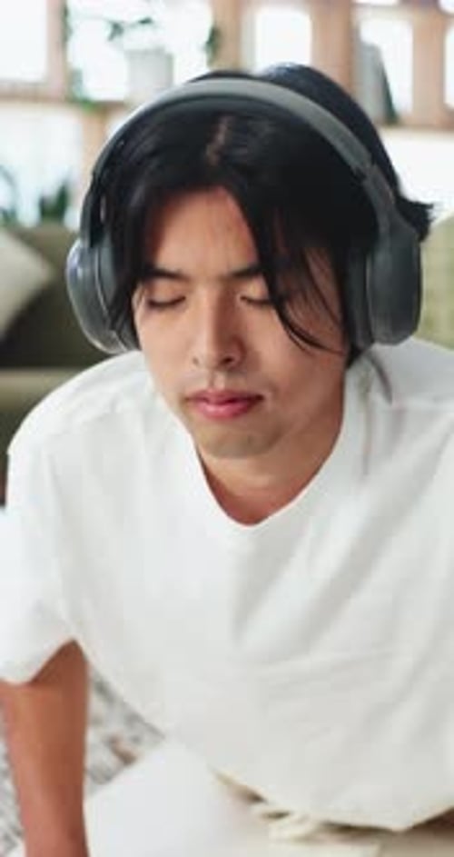 Man, headphones and wellness in home with yoga, stretching or listening to music for mindfulness