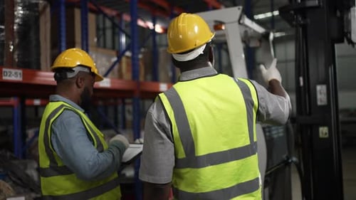 Blue collar workers working at warehouse.