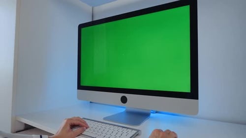 Typing on Keyboard in front of Green Screen Computer