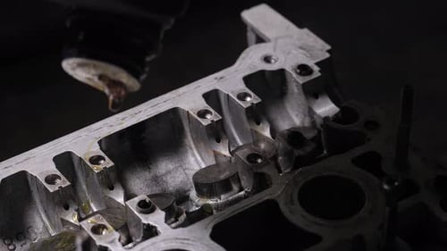 Mechanic pouring oil into engine valves