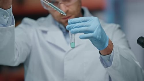Focused Researcher Using Pipette Filling Test Tube in Modern Laboratory Close Up