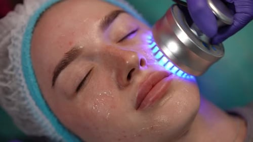 Woman Receives Light Therapy Facial Treatment