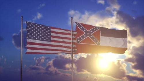 United States and Mississippi State Flags Waving at Sunset
