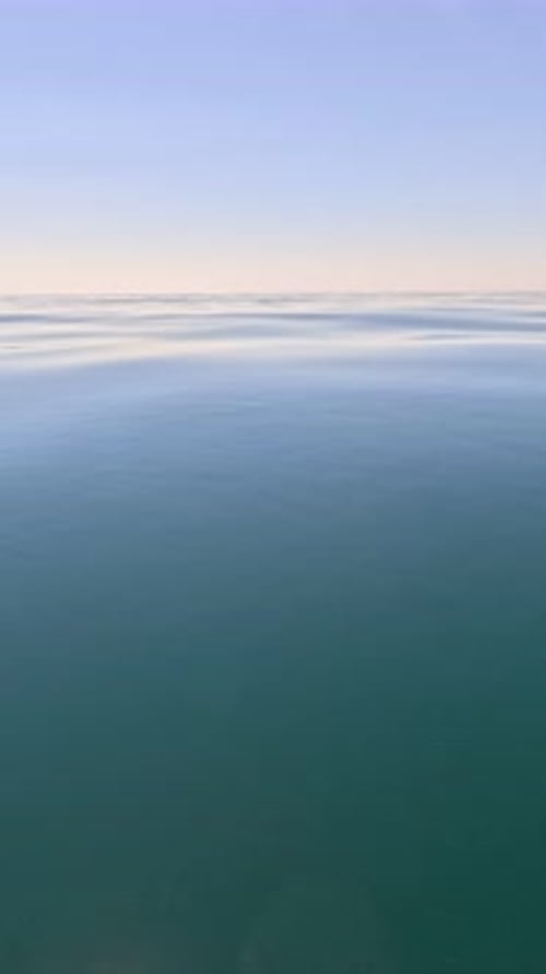 Vertical Aerial View on Sea Water Surface Camera Flies Over Clear Sea Water Sun Glare Abstract