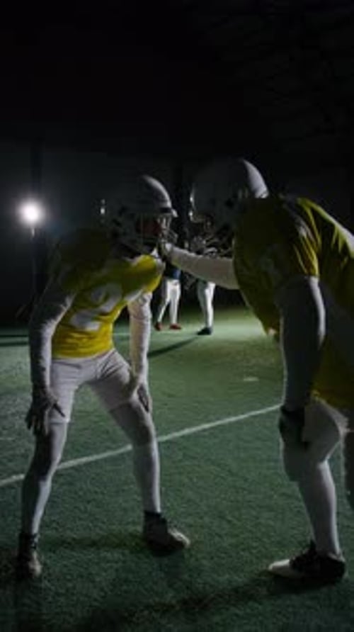 Football Players Face Off in Indoor Arena