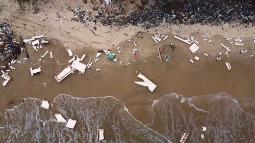 Plastical and metal debris are scattered along the coastline of Malibu beach in Vietnam. Once a tour