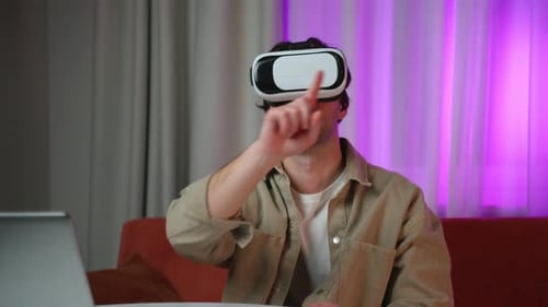 Man Uses VR Headset, Gesturing in Virtual Reality