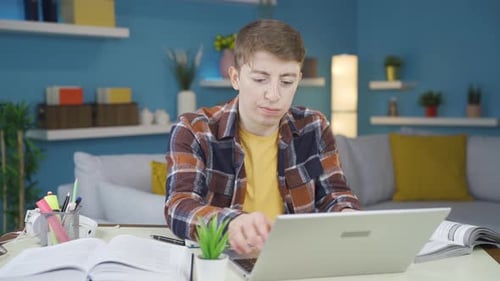 Young Adult Talking to a Laptop at Home
