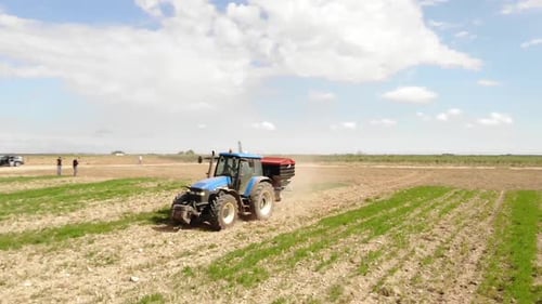 Tractor Farming in a Rural Field, Aerial View