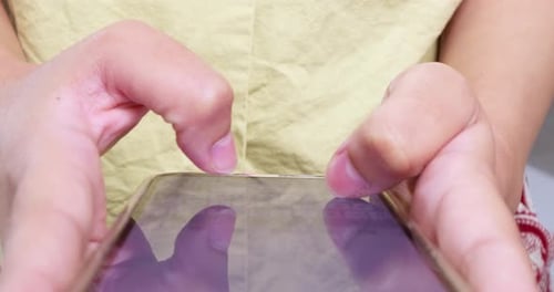 Person engaging with smartphone indoor space digital interaction close-up view modern lifestyle