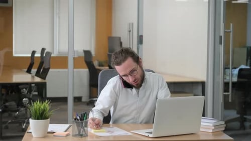 Businessman Talking on Cellphone at Office