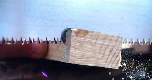 Saw blade slicing through wood, creating wood dust in slow motion, detailed and precise carpentry