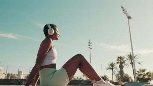 Side view of alone calm girl listening to music on headphones with eyes closed