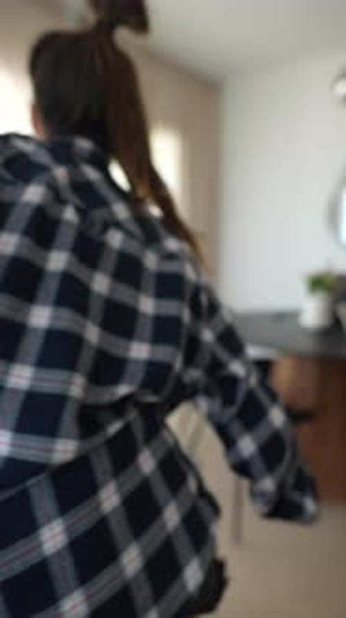 Energetic Woman Dancing Indoors with Joy