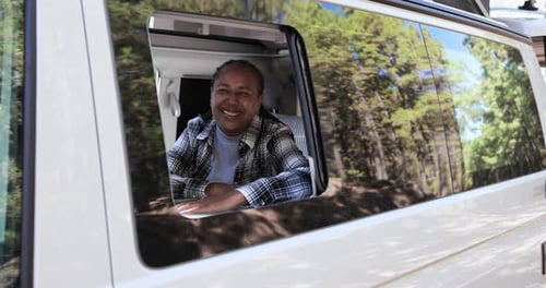 Woman smiling looking out of camper van window