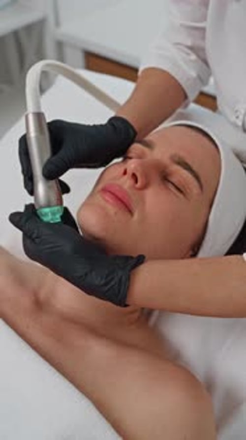 Woman Receiving Cosmetic Facial Procedure in Medical Spa